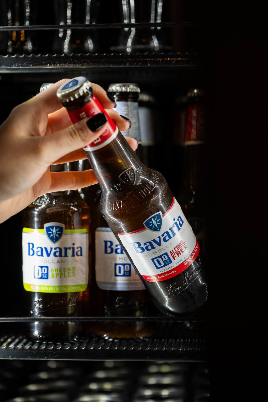 Dłoń wyjmuje butelkę piwa z lodówki